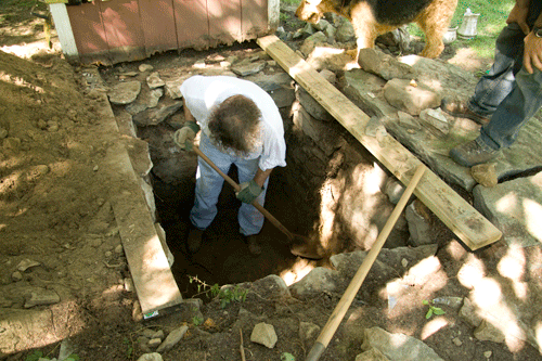 excavation under the outhouse to look for treasure